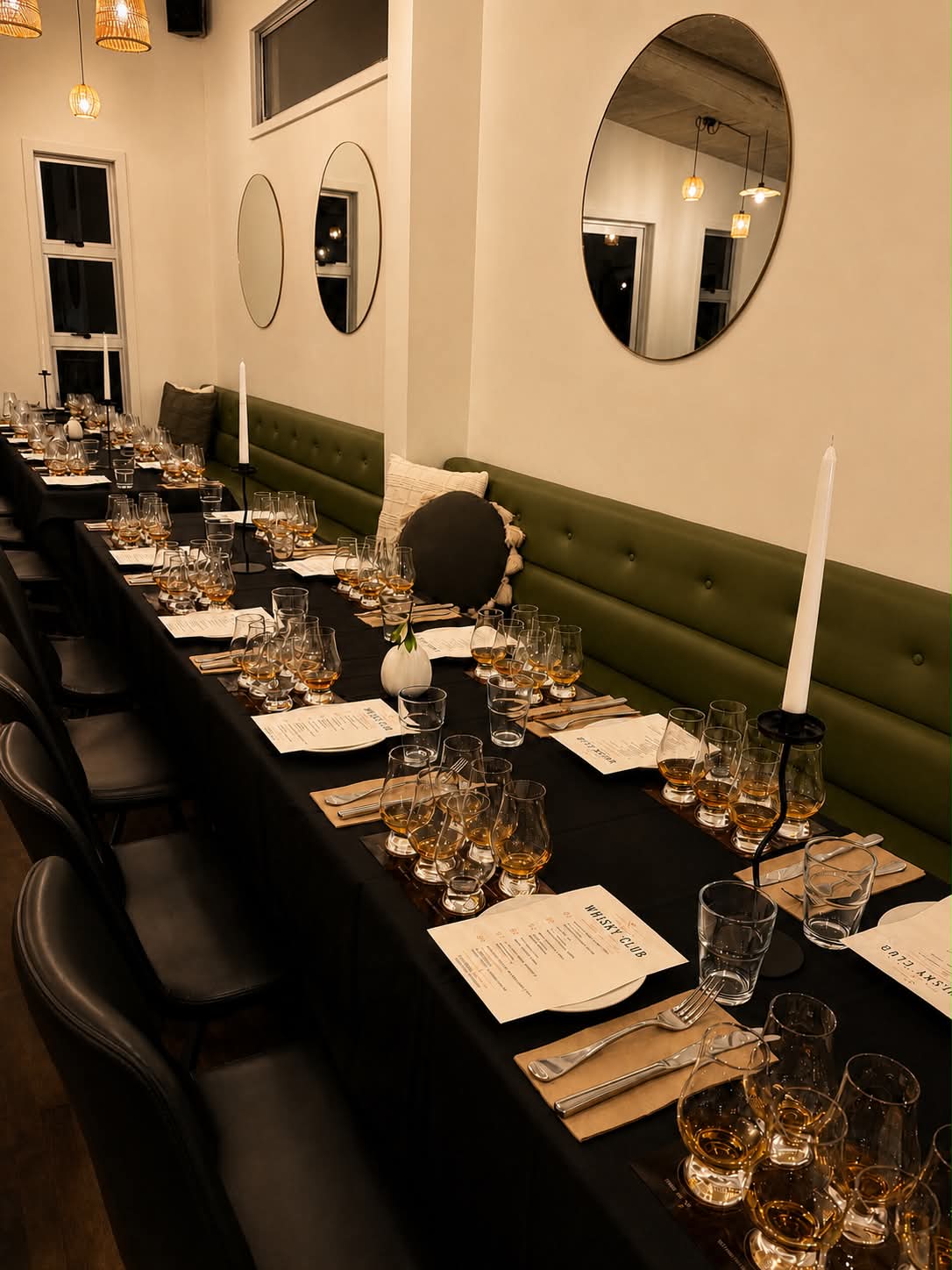 A long table set with whisky tasting glasses for a whisky club evening at The Local